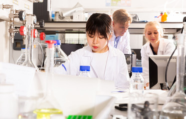 Female Chinese chemist working in laboratory