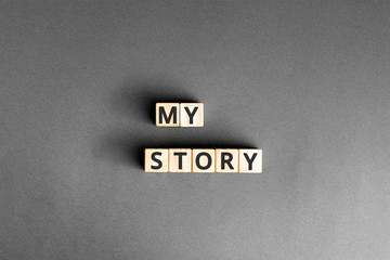My story - phrase from wooden blocks with letters, Personal History Achievement Biography My story concept, grey background
