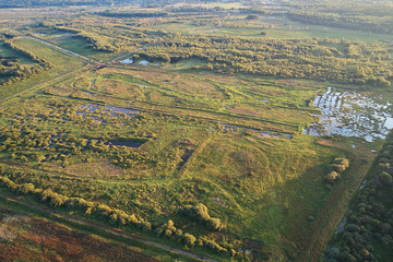 Aerial photography with a drone. Landscape with green forest, road and river.