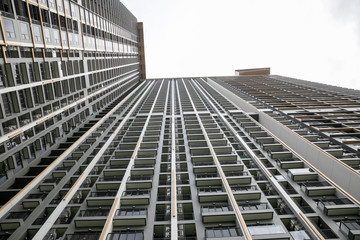 Nonthaburi ,Thailand. -AUGUST 07, 2019  Modern condo building in Nonthaburi - wide angle view from below of a concrete  city tower.