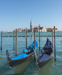 Gondolas near Saint Mark square (San Marco) and San Giorgio di Maggiore church in the background, in Venice, Italy