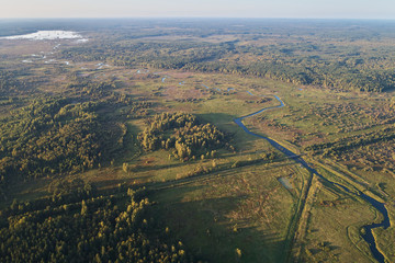 Aerial photography with a drone. Landscape with green forest, road and river.