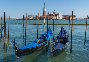 Fototapeta na wymiar Gondolas near Saint Mark square (San Marco) and San Giorgio di Maggiore church in the background, in Venice, Italy