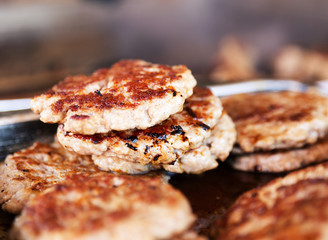 Photograph of grilled pork burgers; food.