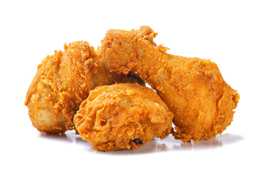 Photo of fried yellow crispy spicy chicken legs on white background