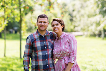 Fototapeta premium people and relationships concept - happy couple in summer park