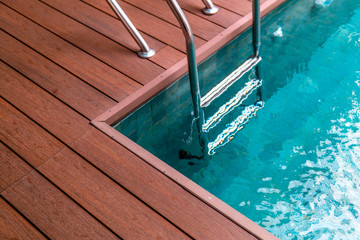 swimming pool handrails with fresh water and wood porch