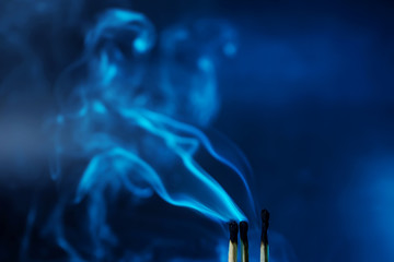 Matches just extinguished in a mystical dark blue light against a dark background. Spectacular...