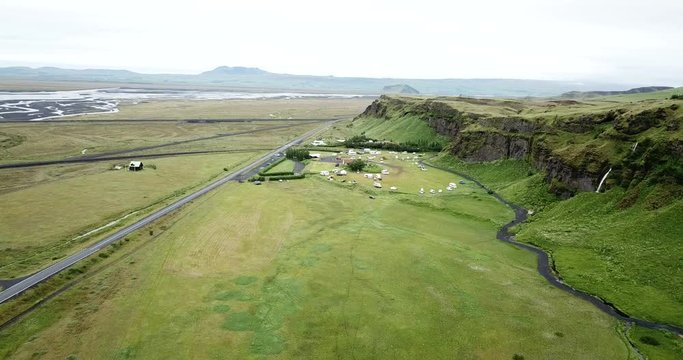 4K Aerial Drone footage from the sky of Iceland waterfall valley in the southern region. Beautiful green Icelandic landscape
