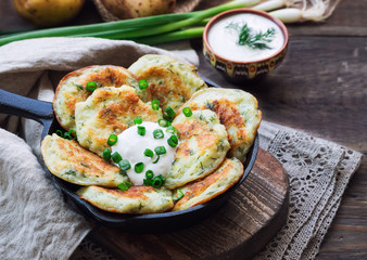 Potato pancakes with dill in iron skillet