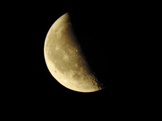 moon on the wane ochre colored on black sky