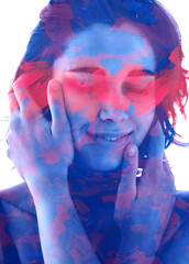 Paintography. Double exposure. Close up of a beautiful young model combined with blue and red hand drawn paintings which overlap and blend into one another