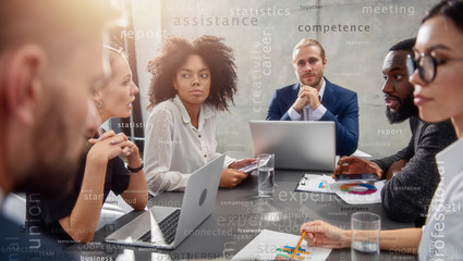 Team of people work together on company statistics in office. concept of t eamwork and partnership. Most important business terms in overlay © alphaspirit