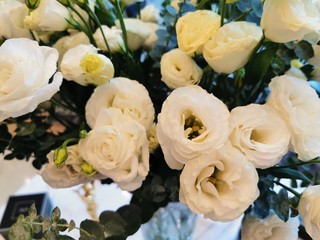 wedding rings on a bouquet of white roses