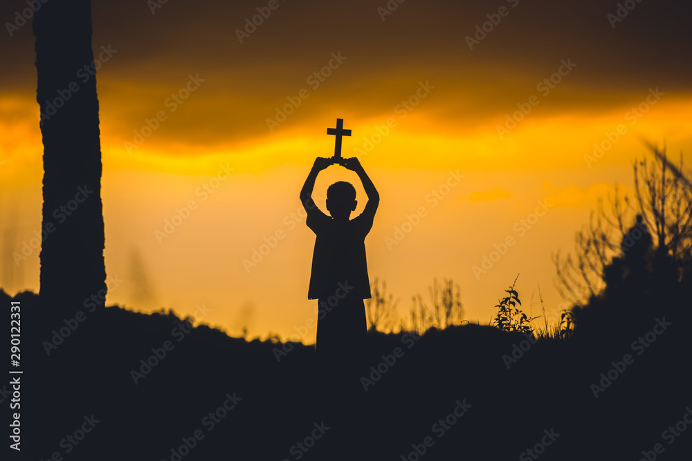 Wall mural children holding christian cross with sunset background,christian silhouette concept. - Wall murals