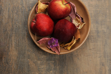 Apple fruit. Red, tasty. Clay color, brown. Aged wood background.