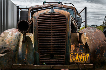 Close-up of the front of an old  1930's truck, now derelict & rusty  a junk yard vehicle, auto,...
