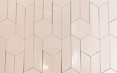 real photo of glossy white hexagonal tiles wall of the bathroom. geometric pattern, abstraction