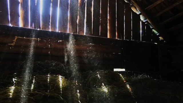 Rays of light penetrate the boards of the old barn HD 1920x1080