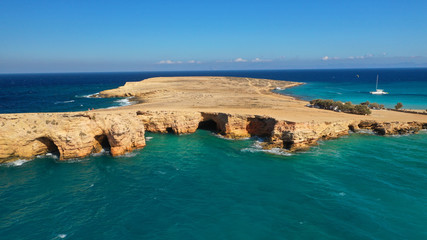 Aerial drone photo of iconic caves of Xylobatis or Ksylompatis in Koufonisi island, Small Cyclades, Greece