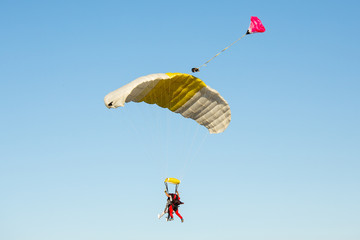 Tandem skydiving on a large parachute.