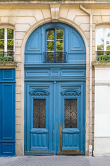 Fototapeta na wymiar Paris, beautiful blue wooden door, typical windows 
