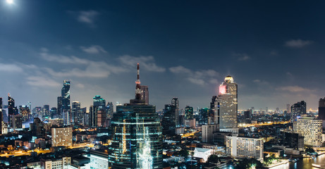 Fototapeta na wymiar City at night with urban buildings. Aerial view.
