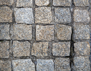 Stone pavers are lined with cobblestones of the same type