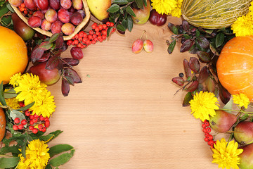Thanksgiving, autumn background with seasonal autumn nature berries, pumpkins, apples and flowers on a wooden background, top view, copy space, flat lay. Happy Thanksgiving concept, selective focus.