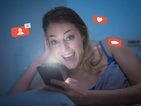 Happy woman online chatting and dating on smartphone with social media notification icons at nigh