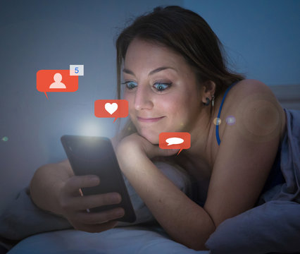 Happy woman online chatting and dating on smartphone with social media notification icons at nigh