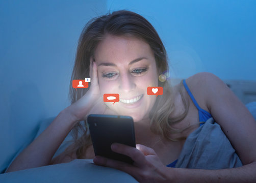 Happy woman online chatting and dating on smartphone with social media notification icons at nigh