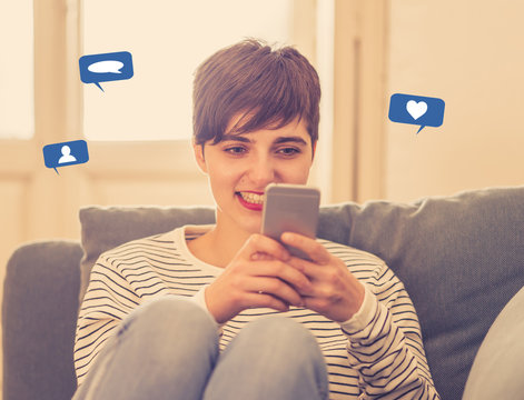 Happy young beautiful woman on on mobile phone with social network notification icons of like, friends and message. Cheerful female on the internet using social media app chatting at home