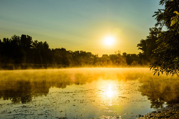 Fog above the water surface. Sunrise at river