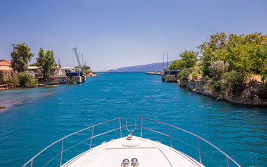 Passing through the Corinth Canal by yacht, Greece. The Corinth Canal connects the Gulf of Corinth with the Saronic Gulf in the Aegean Sea.