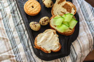 breakfast in bed (roll, sandwich, quail eggs, coffee and more) menu concept. food background. copy space. Top view