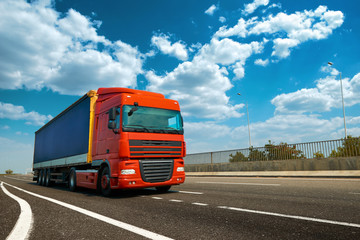 Fototapeta na wymiar Red truck is on highway - business, commercial, cargo transportation concept