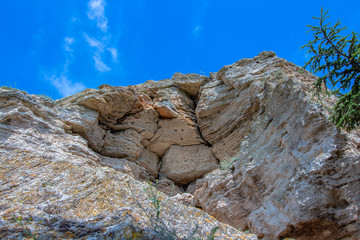 Part of a huge rock above а cave at the ancient fortress of Cape Kaliakra against the background of the azure sky. Northern Black Sea Coast, Bulgaria.