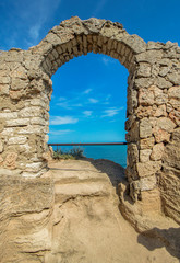The arch of the ancient fortress of Cape Kaliakra above the sea against the background of the azure sky. Northern Black Sea Coast, Bulgaria.