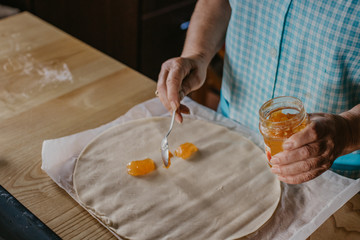 hands with the base of the cake or pizza, cooking preparations