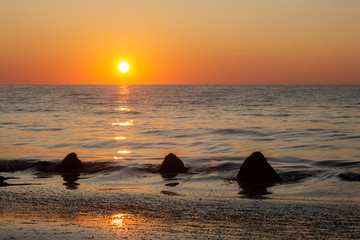 Sunrise with a reflection on the fishing beach in Krapets. Northern Black Sea Coast, Bulgaria.