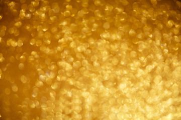 Gold glittering christmas lights. Blurred abstract background.