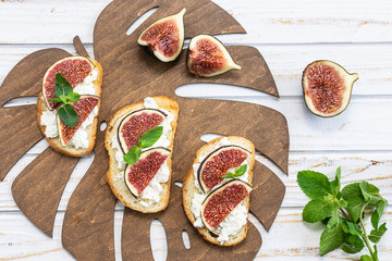 Idea for healthy and tasty breakfast with full grain toasts with mascarpone cheese and ripe aromatic figs.