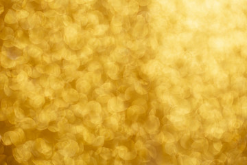 Gold glittering christmas lights. Blurred abstract background.