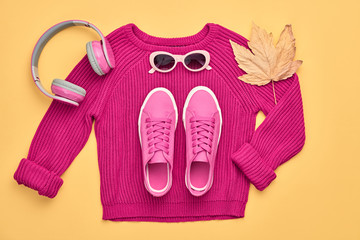 Hipster DJ trendy colorful autumn Outfit. Fall fashion minimal Flat lay. Pink jumper, Stylish sneakers, headphones. Creative Woman Clothes Accessories set, fall Girl fashionable autumnal orange color