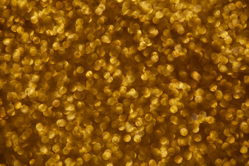 Gold glittering christmas lights. Blurred abstract background.