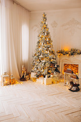 classical interior of a white room with a decorated fireplace, luxury Christmas tree, garlands, candles, lanterns, gifts. day. pink sofa pastel colors