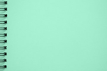 Texture of paper for artwork, notebook, on spiral for sketches, light green mint color. Copy space, background use