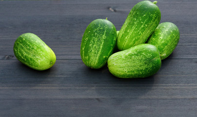  Cucumber on a black wooden background. Organic fresh cucumbers.