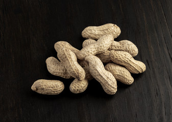 a group of shelled peanuts on wood background